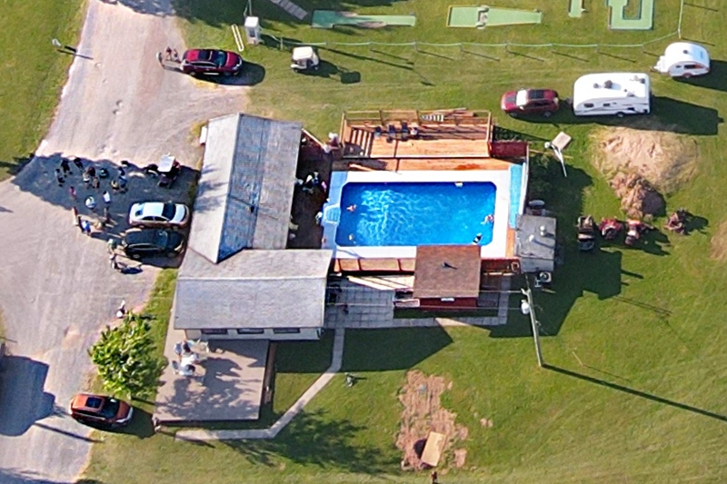 Aerial view of Seal Cove's heated outdoor pool, deck and facilities building