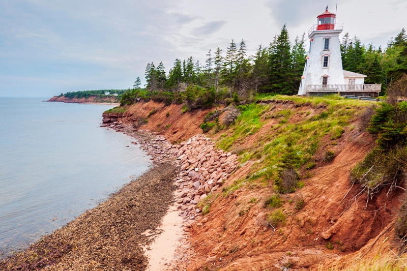 Cape Bear Lighthouse on the red cliffs above the shore