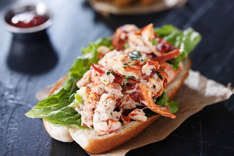 A fresh PEI lobster roll piled high on a toasted bun
