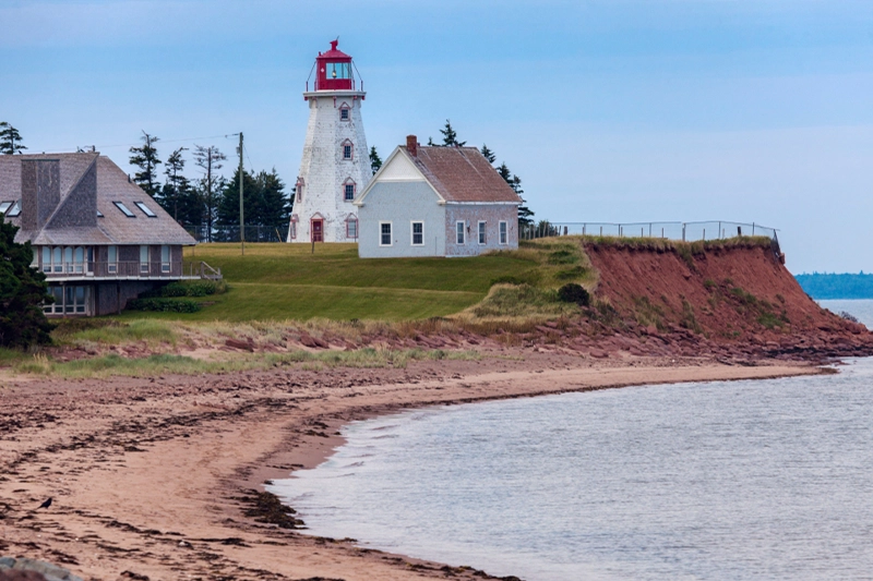 Panmure Island Lighthouse above the red cliffs and sandy beach